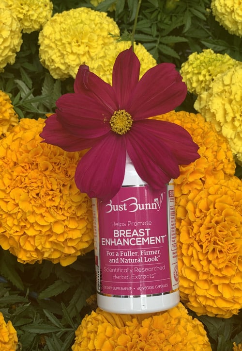 bottle of Breast Enhancement Supplement and flowers