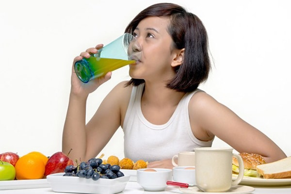 lady drinking juice and fruits for a healthy body
